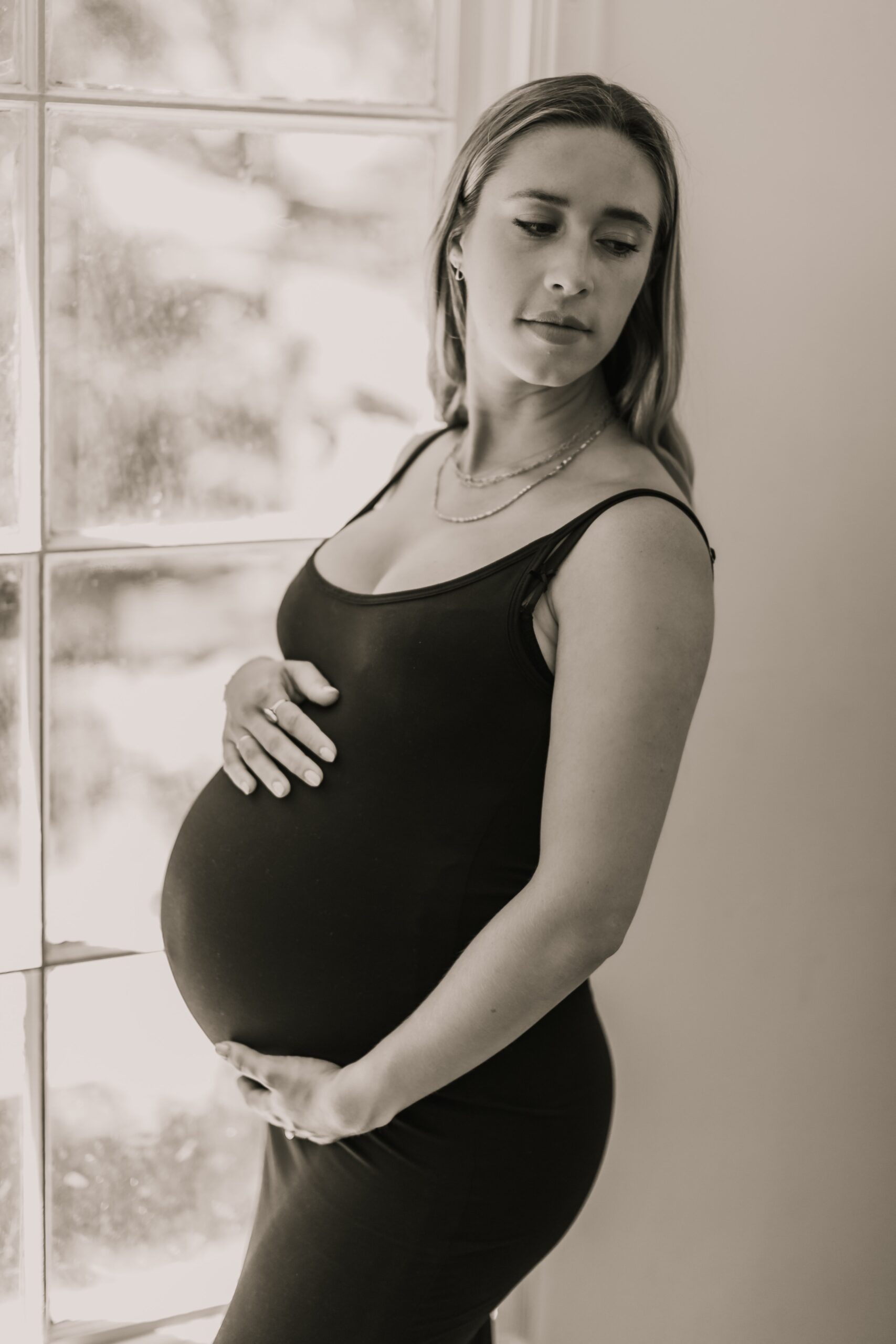 Pregnant woman posing during a maternity session at a studio in san diego