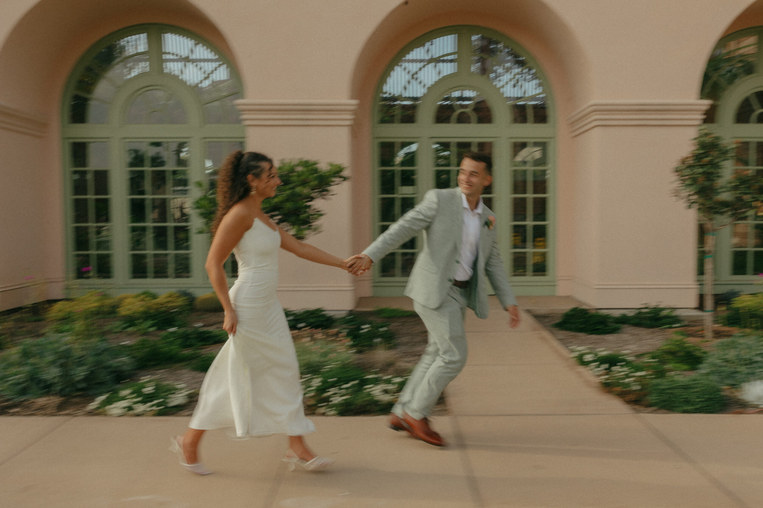 portraits of a bride in a fitted white gown and a groom in a grey suit at Balboa Park in San Diego